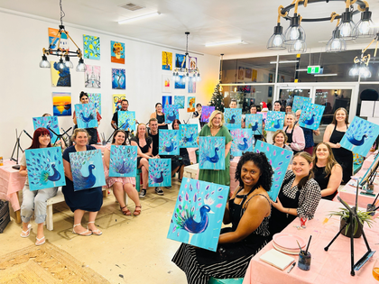 Paintelaide Studio Paint and Sip. All guests posing with their artwork at the end of the session.